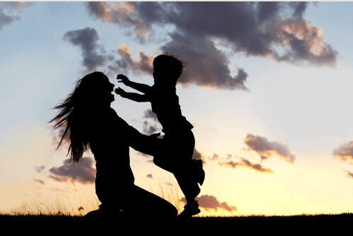 mother and son playing in the sunset