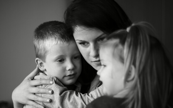 Mother hugging kids
