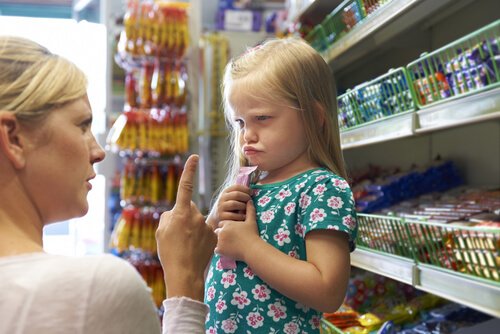 a mother is scolding a little girl.
