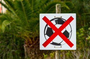 sign banning children playing soccer