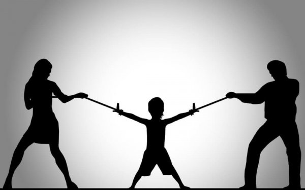 Parents fighting for child in parental alienation syndrome.