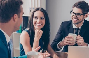 Three people are having a business meeting.