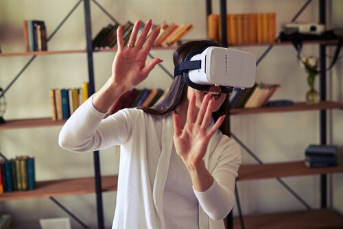 A woman wearing virtual reality glasses.