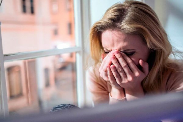 A woman feeling down and crying.