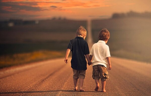 Types of friends: two boys walking down a road holding hands.