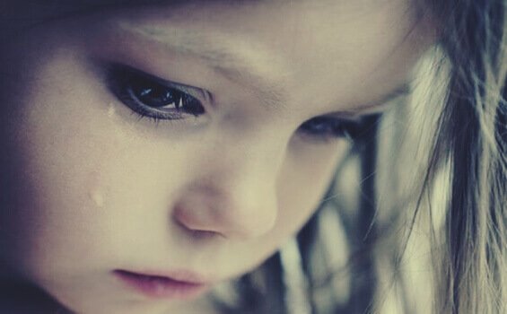 A girl crying because her childhood was stolen.
