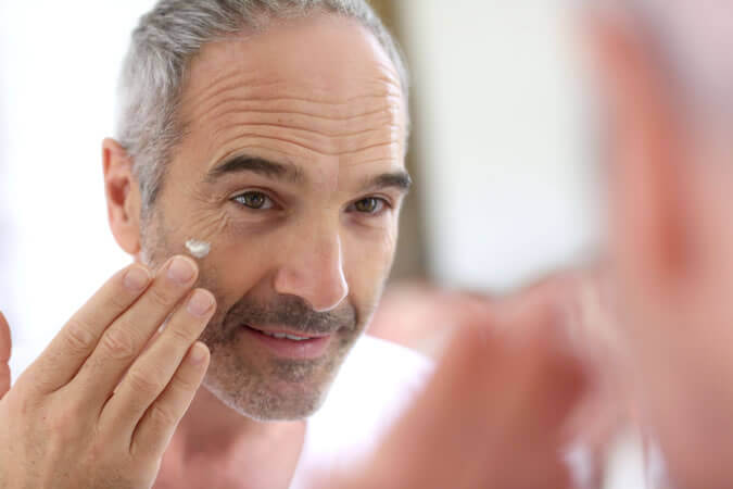 A man applying eye cream.