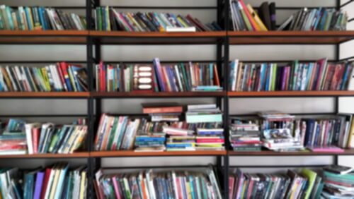 A messy bookshelf in hoarding disorder.