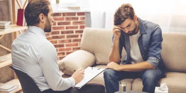 A patient in therapy with his psychologist.