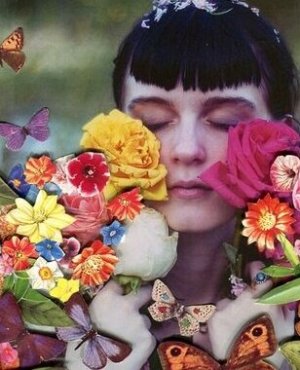 A woman covered by flowers.