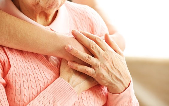 A woman hugging an older lady.