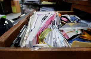 An unorganized crowded drawer.