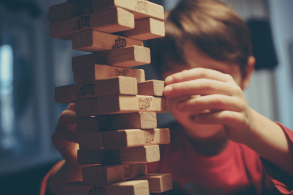 A boy playing jenga.