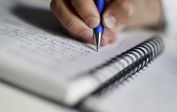 hand writing in notebook using the feynman technique