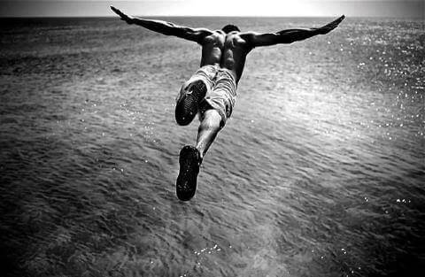 Adrenaline addicts diving into the ocean.
