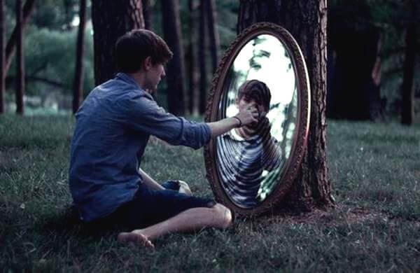 A man looking in a mirror representing Dorian Gray syndrome