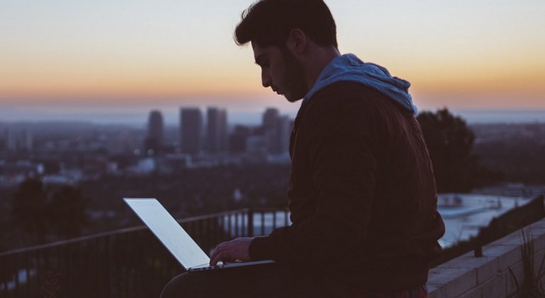 A man using a laptop to be successful at work.