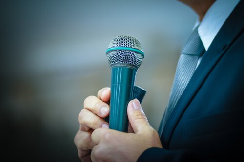man with stage fright holding microphone