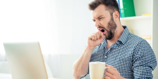 Bored man yawning out of procrastination.