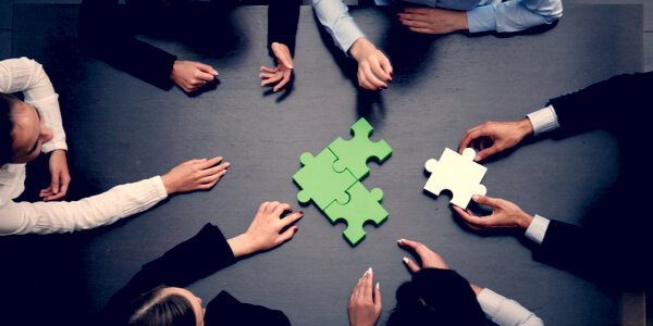 Business people with jigsaw