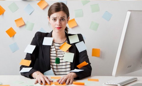 Overworked woman with post-it's stuck to her.