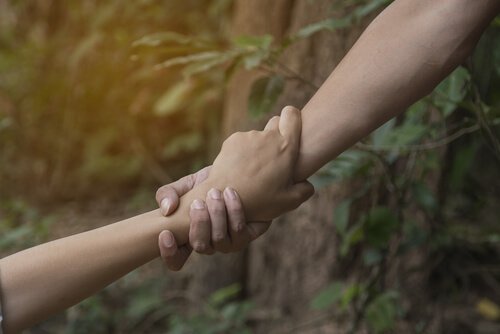 One hand helping another.