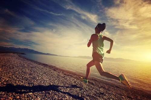 woman jogging along the shore
