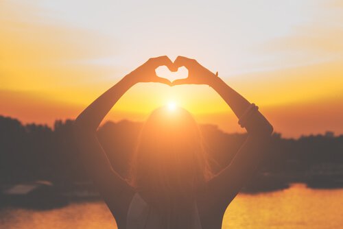 woman making a heart with her hand