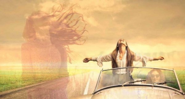 woman who has overcome depression standing up in a convertible