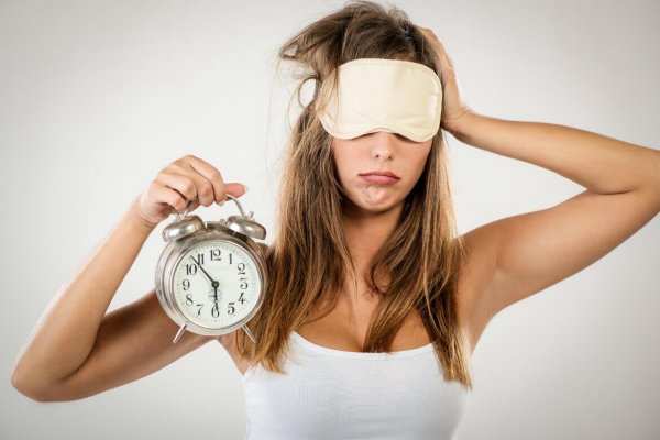 woman with alarm clock representing circadian rhythm sleep disorder