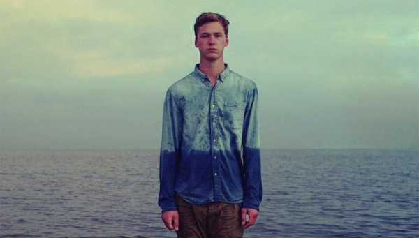 Hiding your feelings: a boy by the sea.