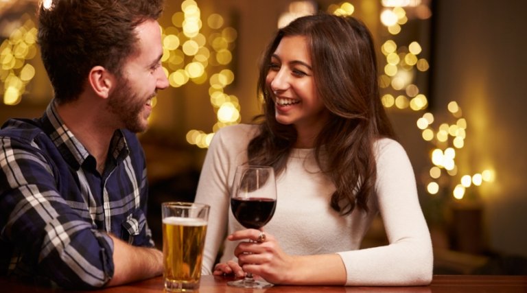 two people talking over some drinks