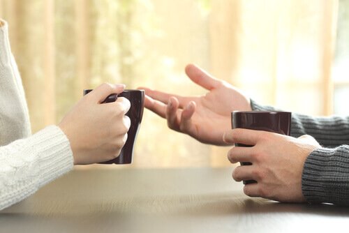hands of two people talking about a criticism