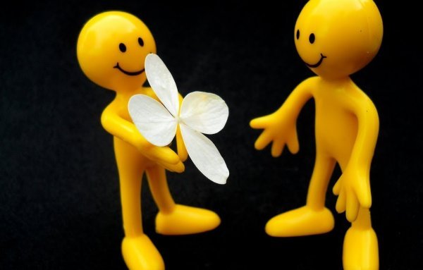 Offering a flower.