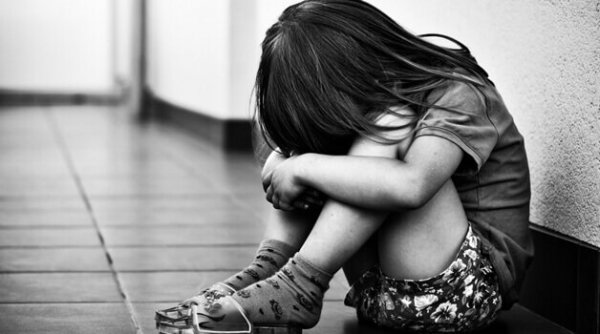 little girl curled up waiting for an absent mother