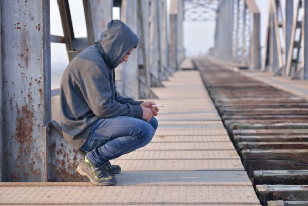 Sad teenager on bridge