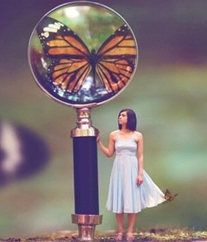 woman looking at butterfly