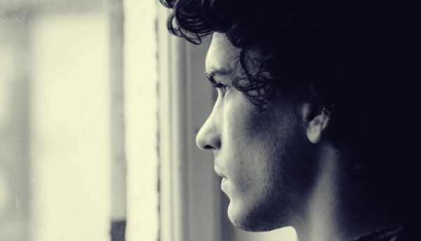 A boy looking through the window.