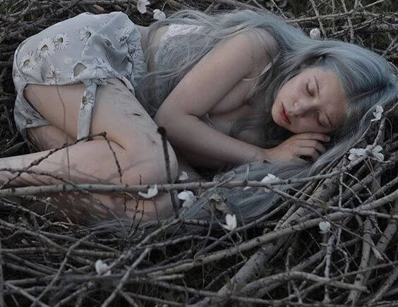 girl laying on branches
