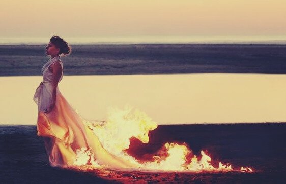 Woman with flaming dress - symbol of being self-destructive
