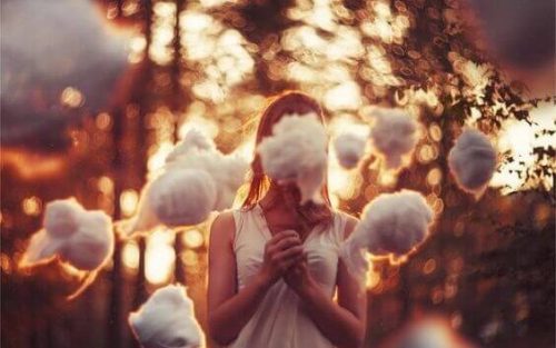 A woman with cotton in front of her face.