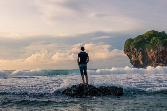 To simplify life man stands on rock