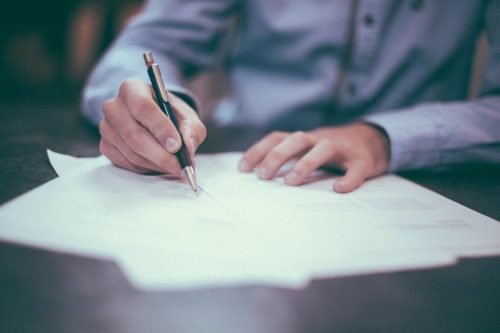 Man writing down resolutions.