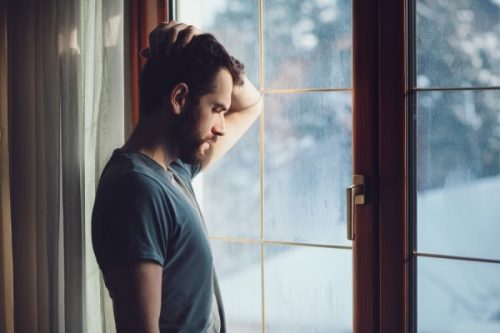 man looking through window
