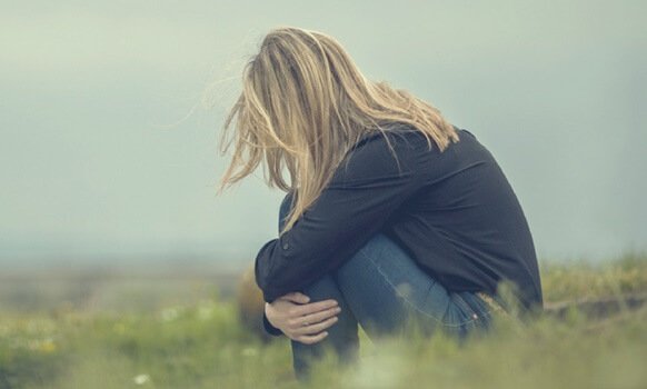 girl sitting in field