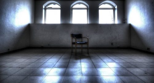 A chair in an empty room.