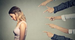 Fingers pointing at a woman.