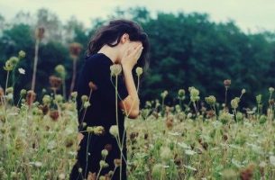 Woman covering her face.