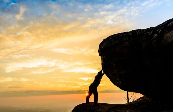 Man leaning on a rock.