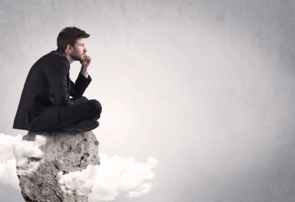 A man sitting on a rock.
